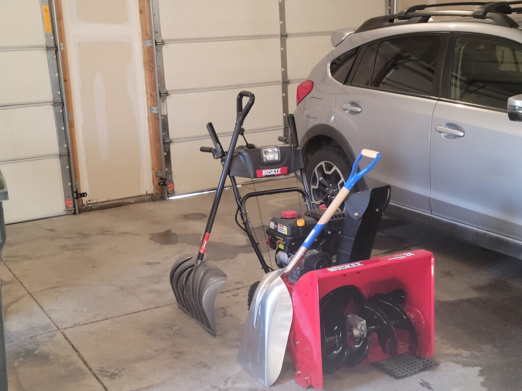 Snowblower and shovels in my garage.