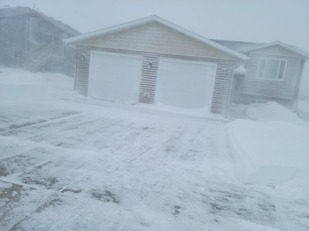 My cleared driveway with my house obfuscated by the blizzard.
